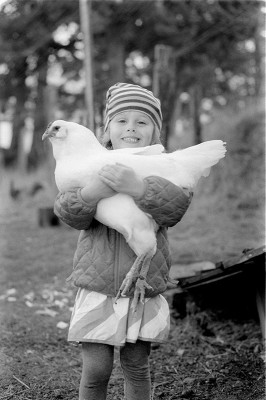 Girl holding a chicken
